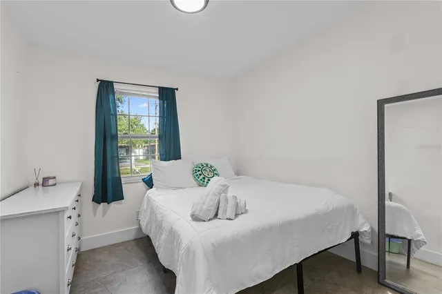 a bedroom with a bed and a table