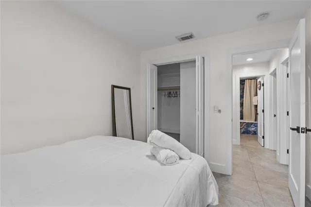 a bedroom with a bed and a closet