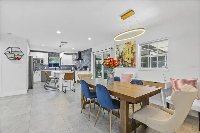 a view of a dining room with furniture and a kitchen
