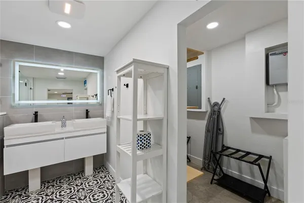 a room with a table chairs and a refrigerator