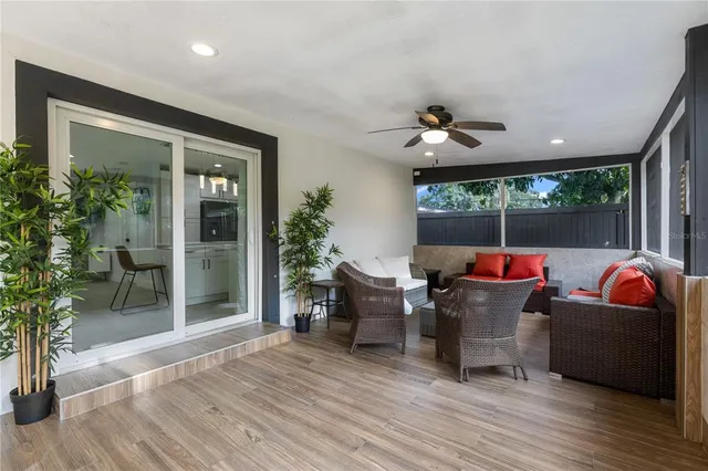 a outdoor living space with furniture potted plant and a large window