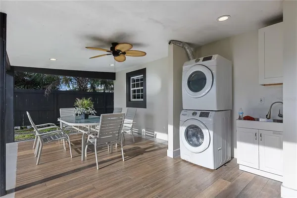 a view of a dining room with furniture a chandelier and wooden floor