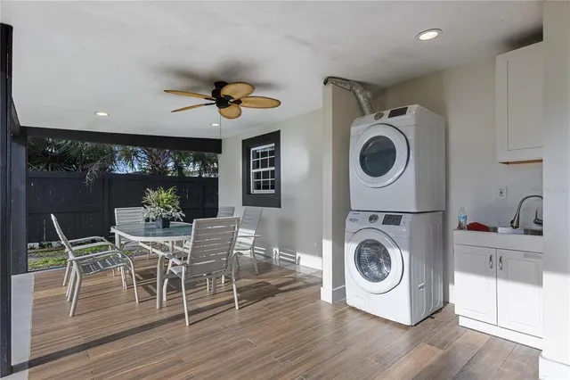 a view of a dining room with furniture a chandelier and wooden floor