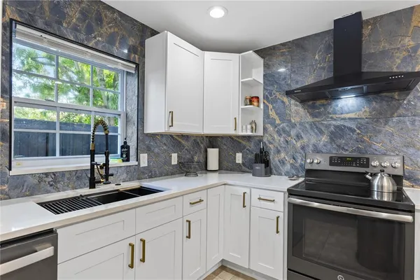 a kitchen with a sink stove and cabinets