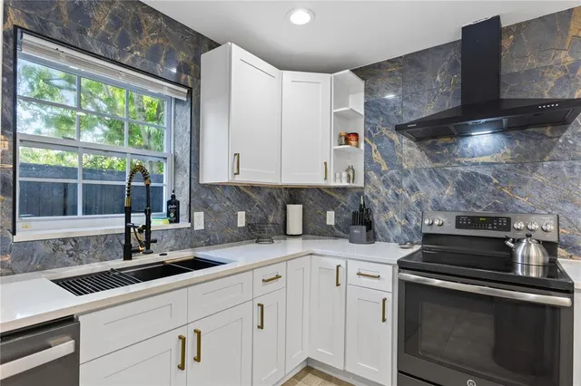 a kitchen with a sink stove and cabinets