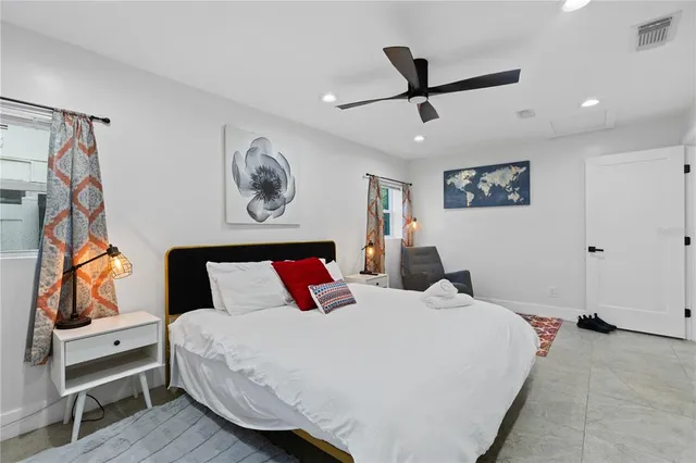 a bedroom with a bed and a painting on the wall