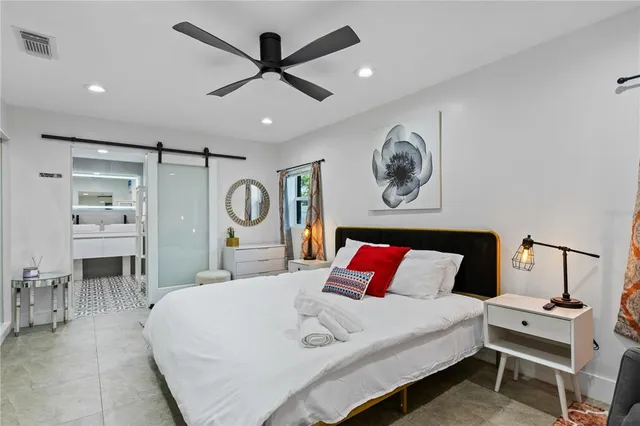 a bedroom with a bed and a chandelier