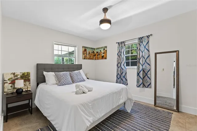 a bedroom with a large bed and a window