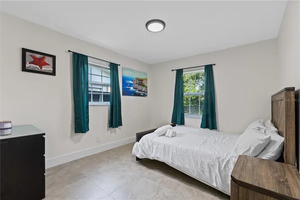 a bedroom with a bed and window