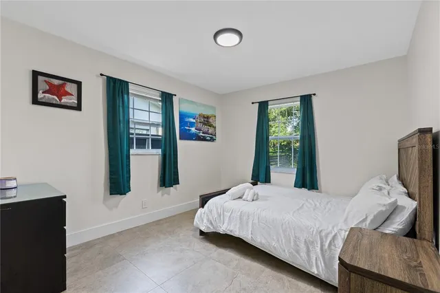 a bedroom with a bed and window