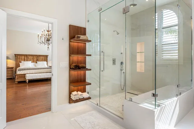 a bathroom with a tub shower and mirror