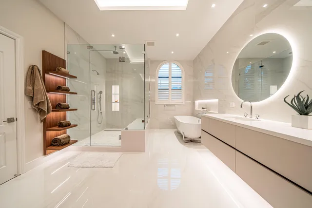 a large bathroom with a double vanity sink a mirror and a shower