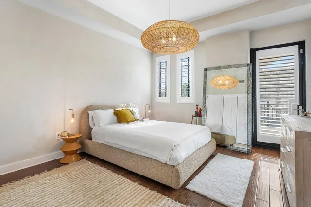 a bedroom with a bed and a chandelier