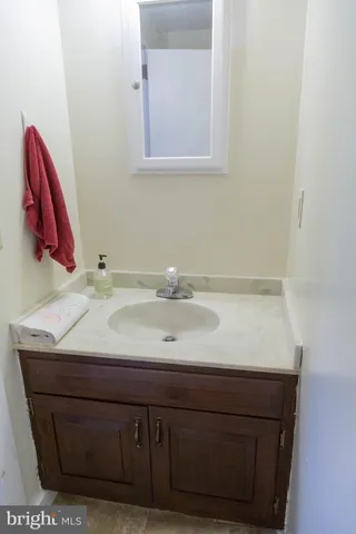 a view of staircase with lots of frames on wall and a window