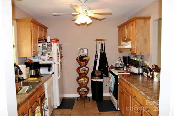 a view of a kitchen with fridge and workspace