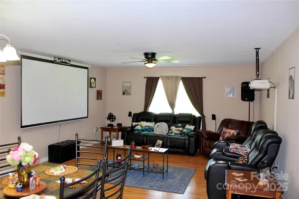 a living room with furniture a window and a lamp