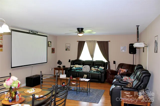 a living room with furniture a window and a lamp