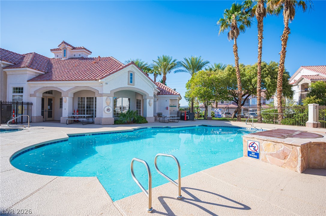 8555 West Russell Road, Unit 2062 Las Vegas, NV 89113 - Photo 33 of 35 A refreshing pool area with inviting waters, perfect for leisure under the bright sun.