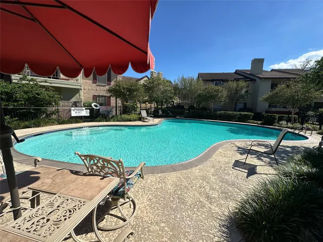 a view of a swimming pool with a patio