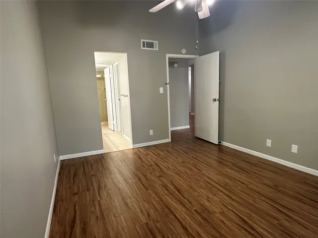 wooden floor in an empty room with a mirror