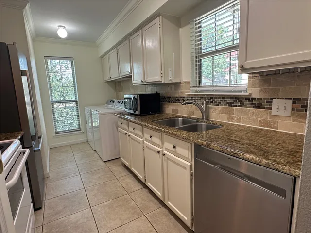 a kitchen with stainless steel appliances granite countertop a sink stove and cabinets