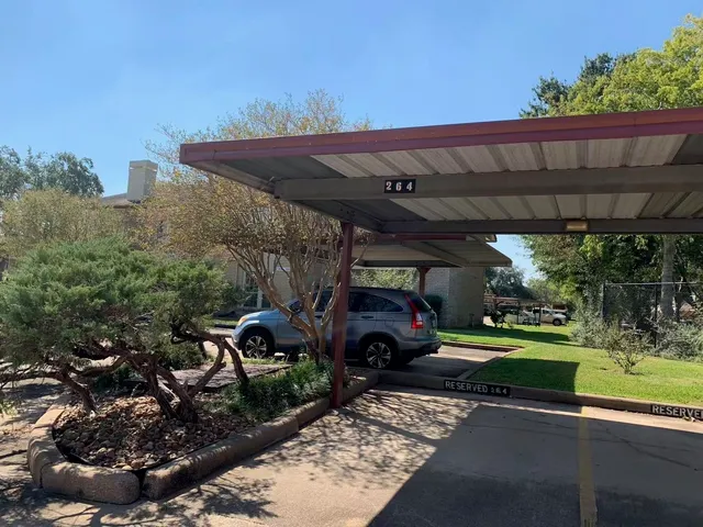 a view of a porch with furniture and a small yard