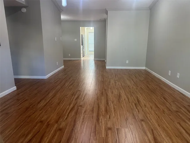 a view of wooden floor and brick walls