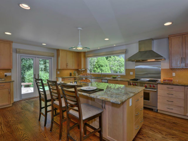 5500 Alpine Road Portola Valley, CA 94028 - Photo 13 of 24 a kitchen with stainless steel appliances granite countertop wooden floor a stove a sink a refrigerator and chairs