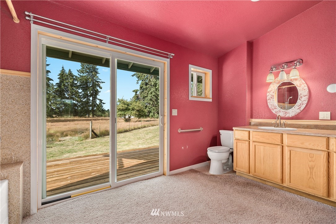7625 187th Avenue Southwest Rochester, WA 98579 - Photo 16 of 38 a bathroom with a toilet a sink and a large window