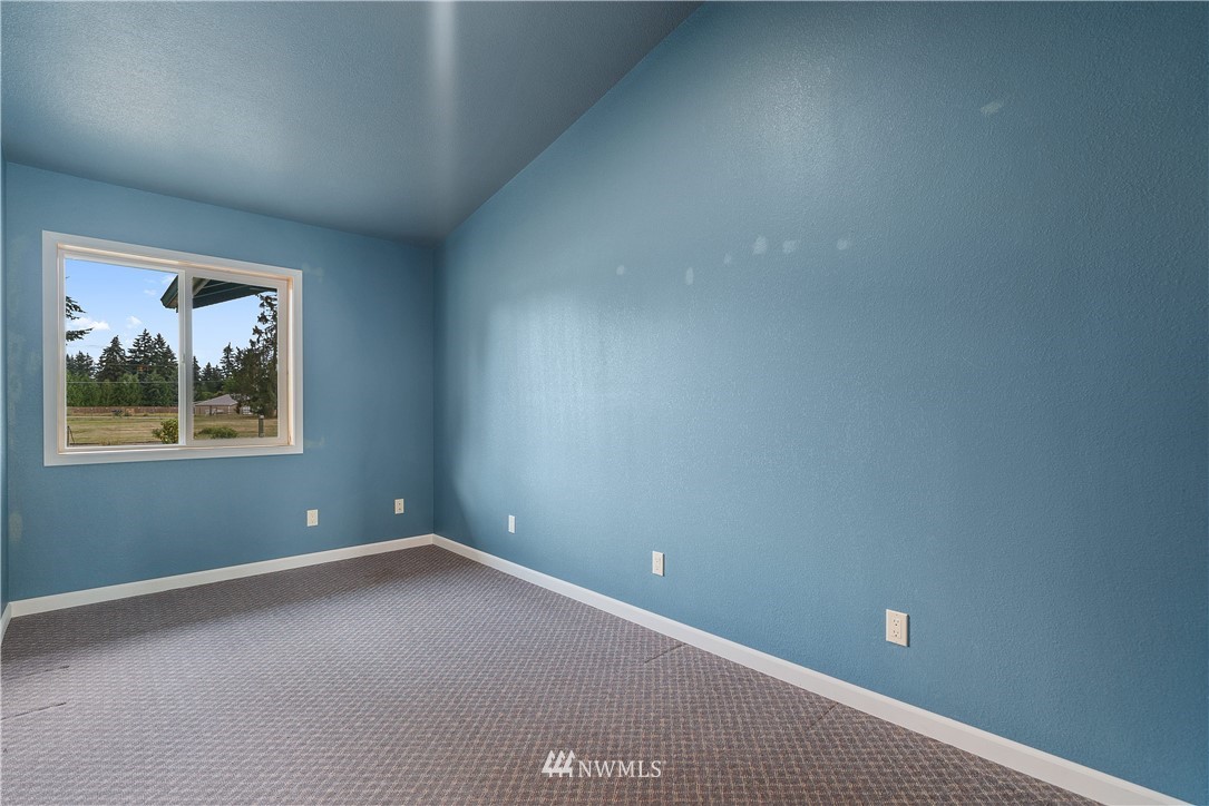 7625 187th Avenue Southwest Rochester, WA 98579 - Photo 18 of 38 a view of an empty room with a window
