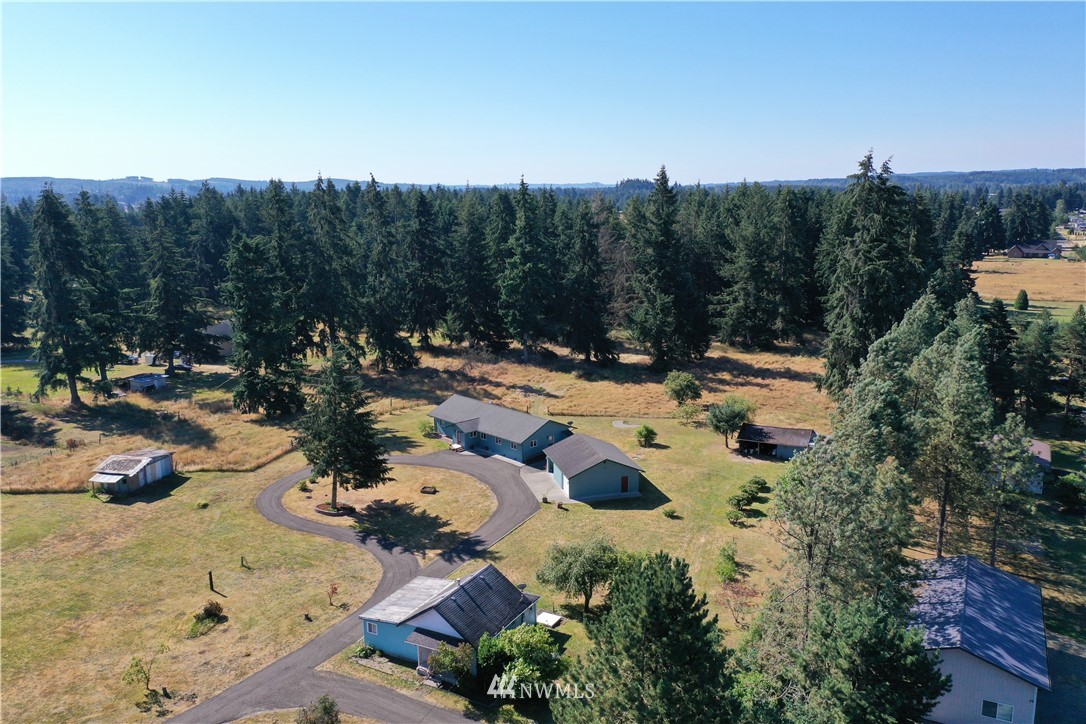 7625 187th Avenue Southwest Rochester, WA 98579 - Photo 25 of 38 a view of a swimming pool with an outdoor space and seating area