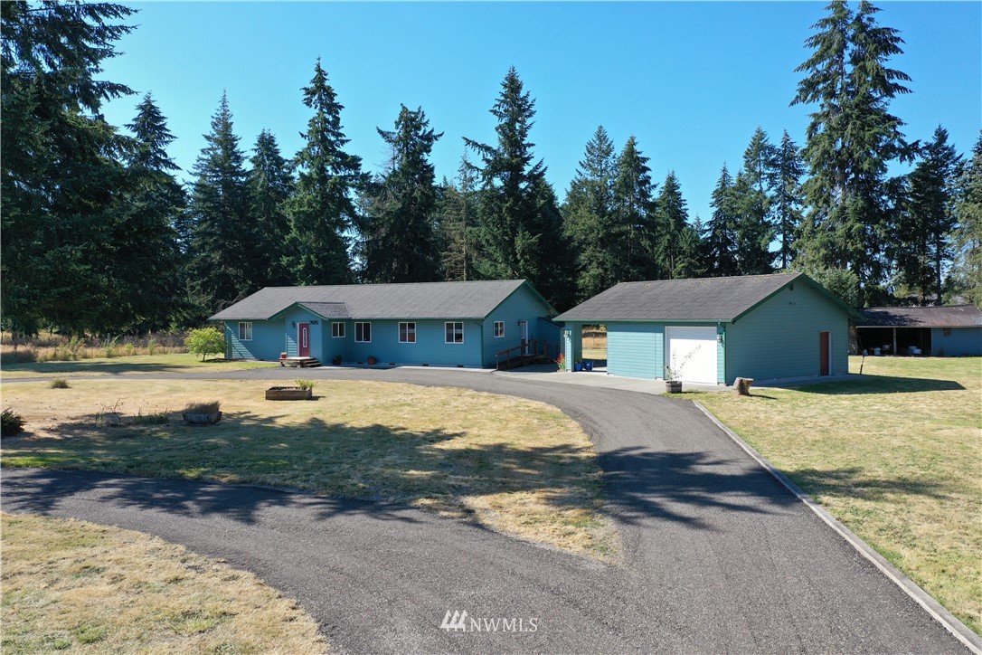 7625 187th Avenue Southwest Rochester, WA 98579 - Photo 27 of 38 a front view of house with yard and trees in the background