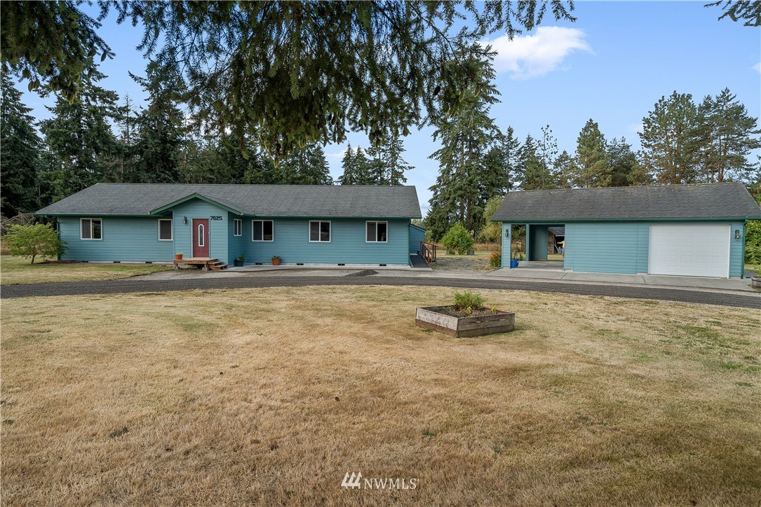7625 187th Avenue Southwest Rochester, WA 98579 - Photo 30 of 38 a front view of a house with a yard