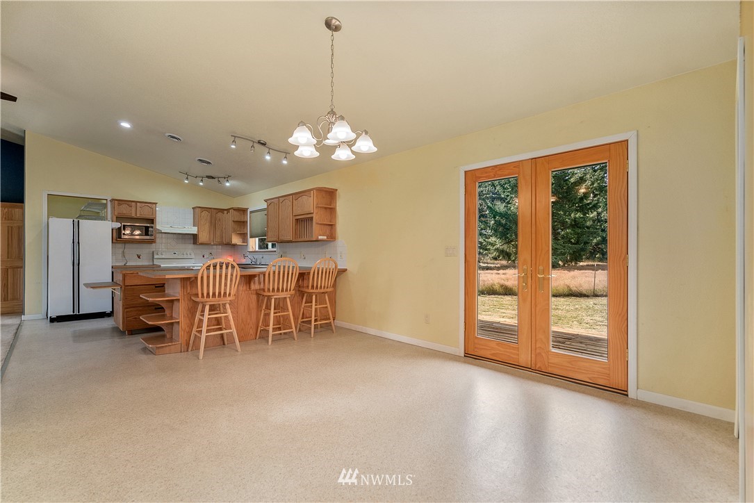 7625 187th Avenue Southwest Rochester, WA 98579 - Photo 4 of 38 a view of a dining room with furniture and window