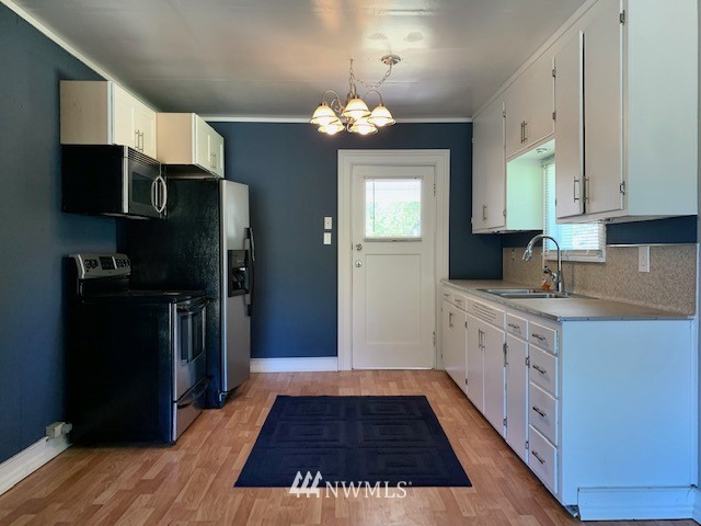 7625 187th Avenue Southwest Rochester, WA 98579 - Photo 37 of 38 a kitchen with stainless steel appliances a refrigerator and a stove top oven