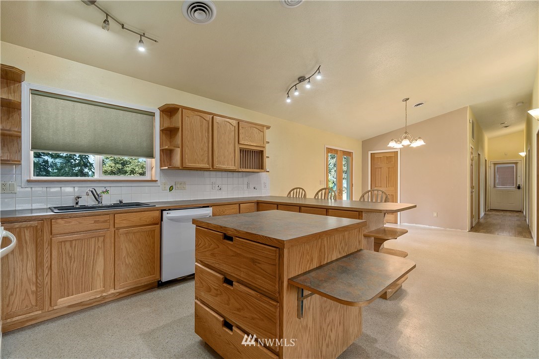 7625 187th Avenue Southwest Rochester, WA 98579 - Photo 9 of 38 a kitchen with a sink stove and cabinets