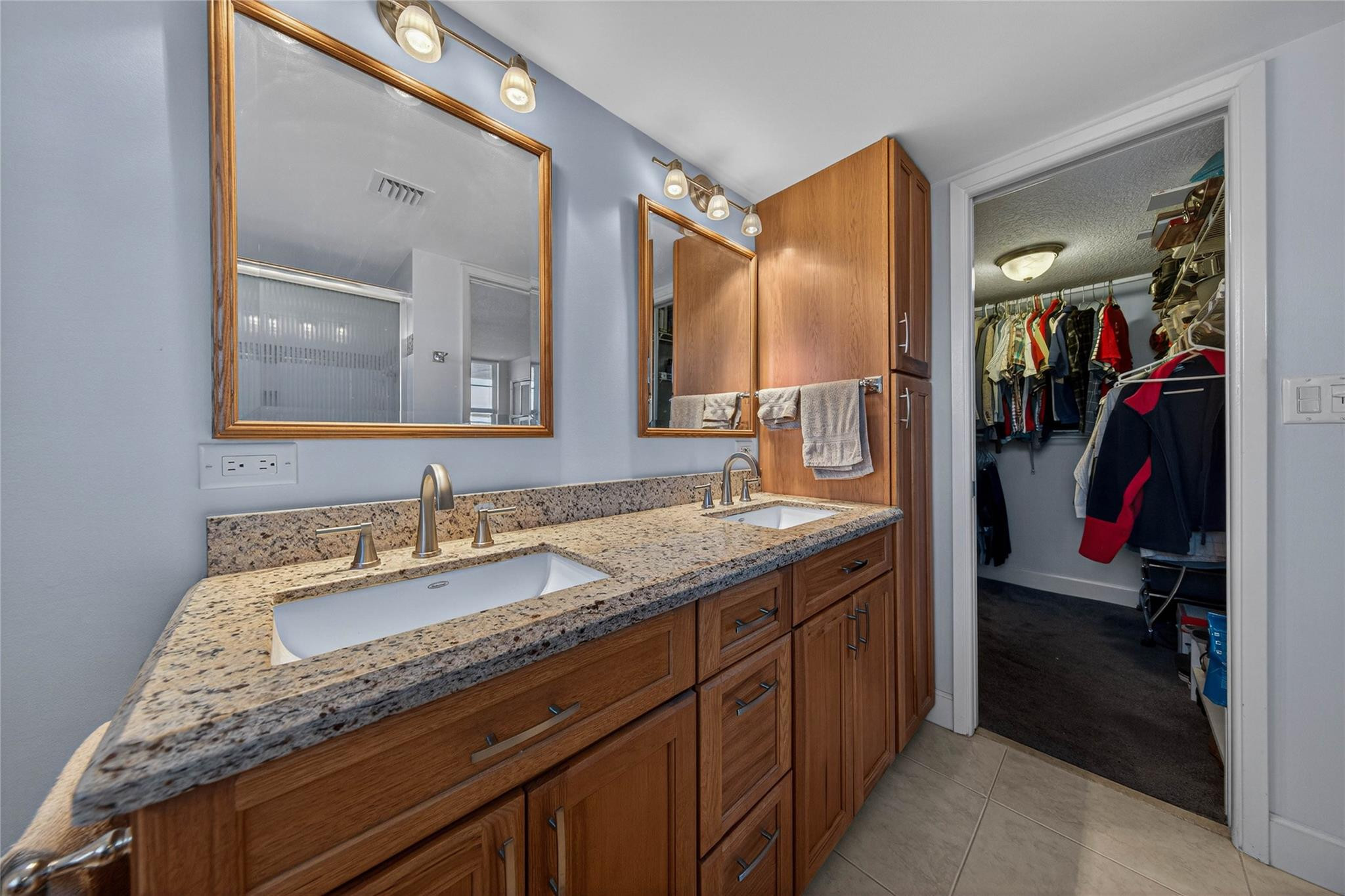 3150 Northeast 48th Court, Unit 414 Lighthouse Point, FL 33064 - Photo 19 of 33 a en suite bathroom with a granite countertop sink and a mirror