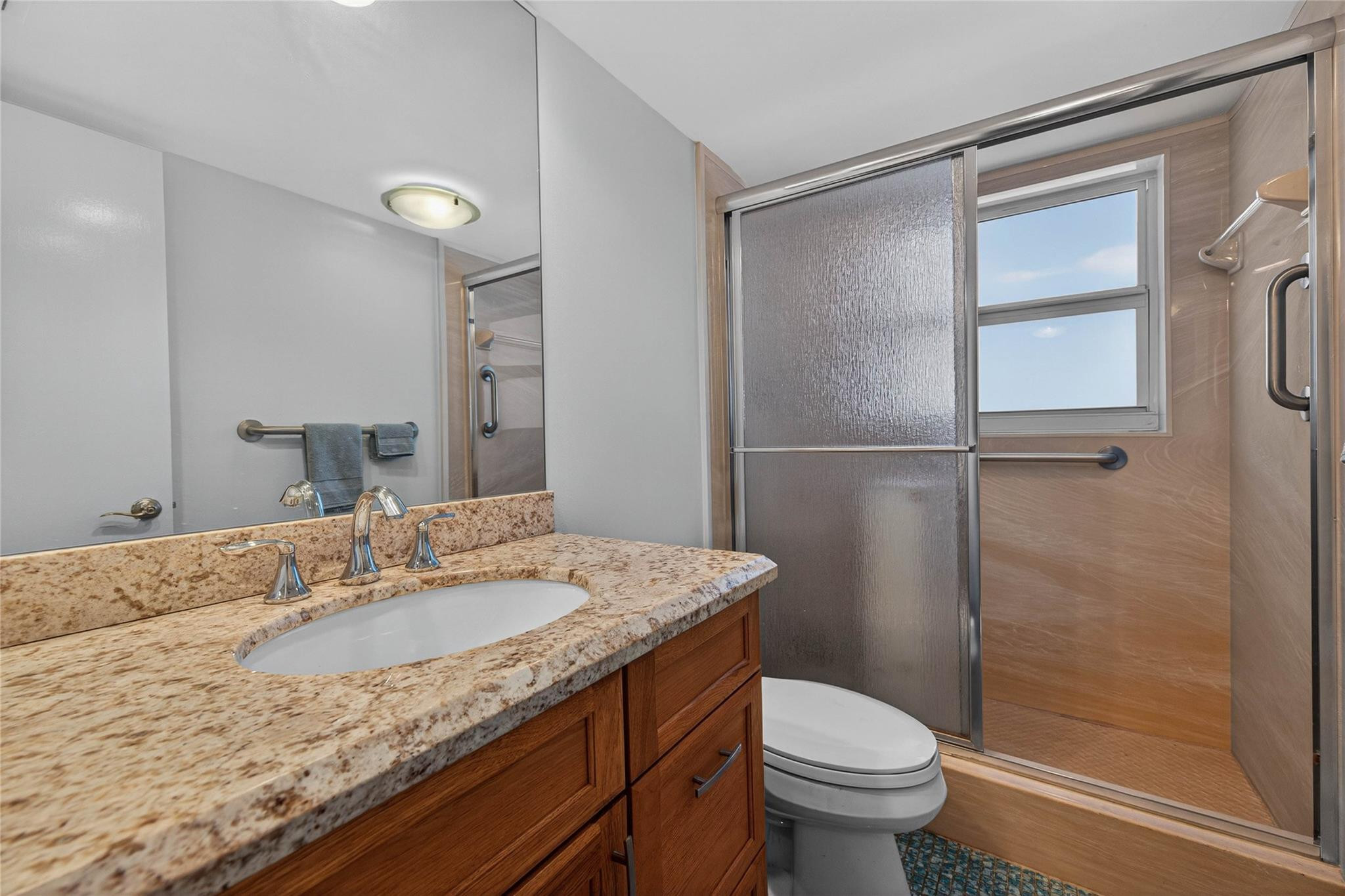 3150 Northeast 48th Court, Unit 414 Lighthouse Point, FL 33064 - Photo 23 of 33 a bathroom with a granite countertop sink toilet and shower