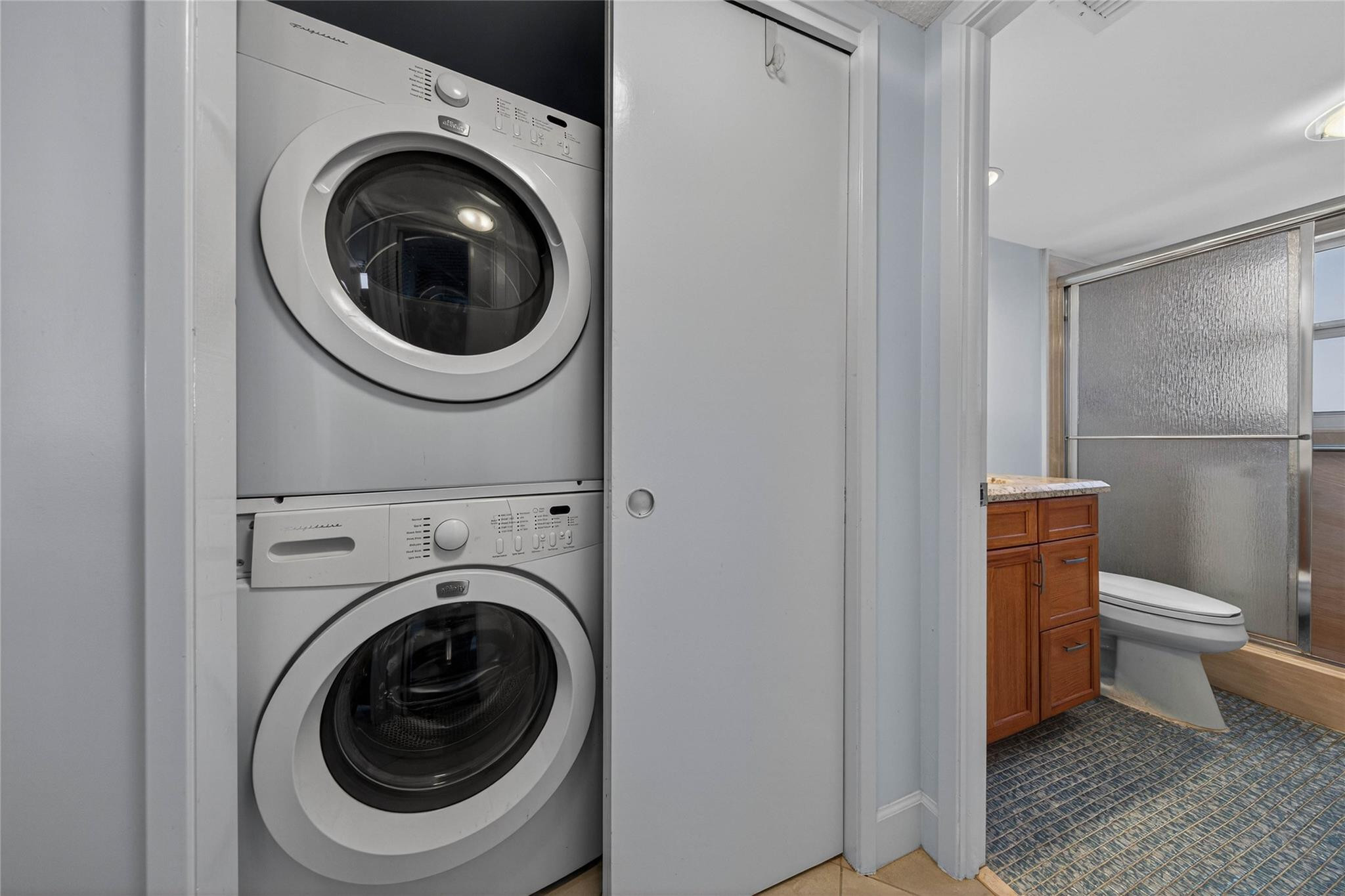 3150 Northeast 48th Court, Unit 414 Lighthouse Point, FL 33064 - Photo 24 of 33 a bathroom with a toilet and a sink