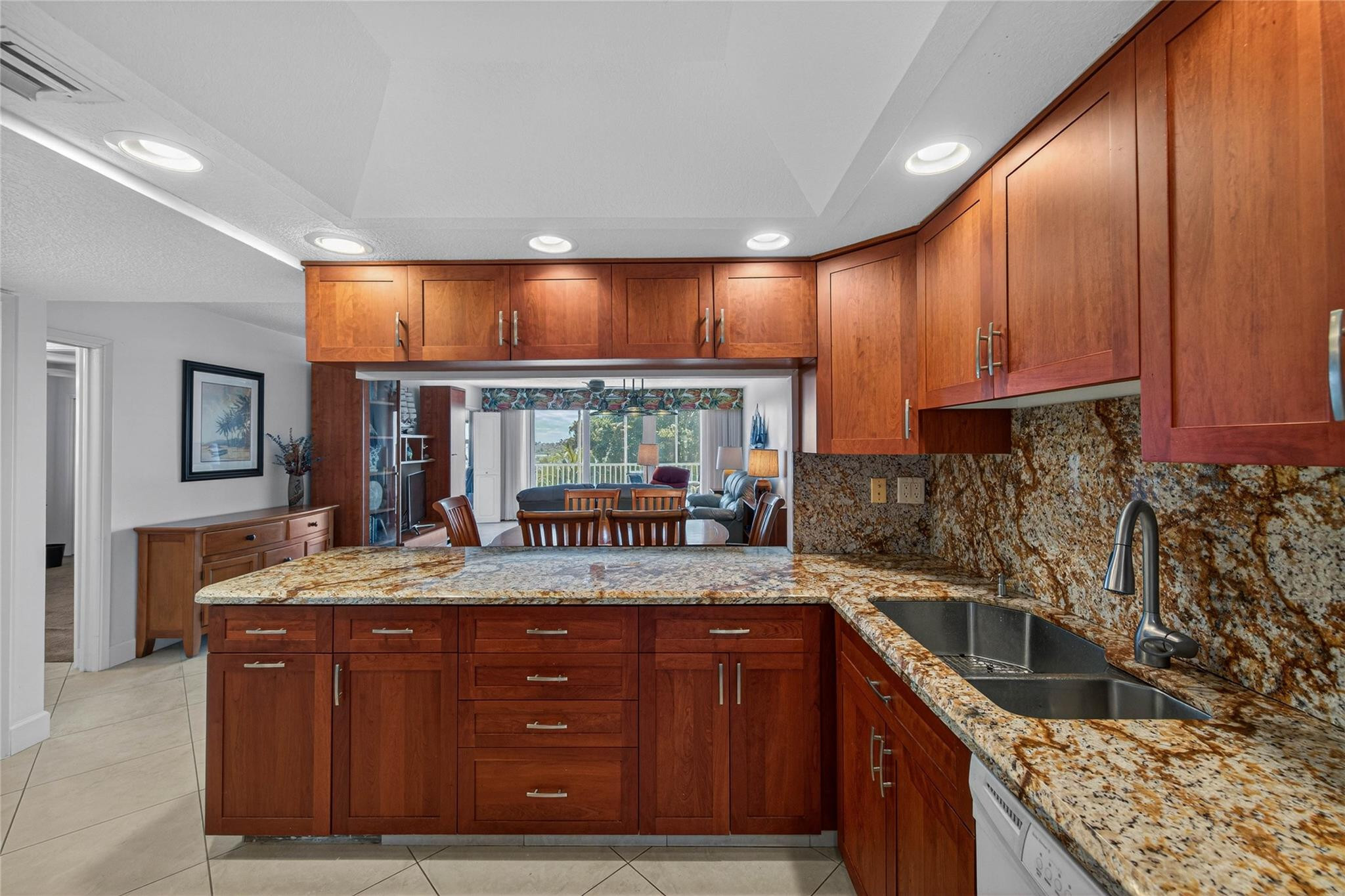 3150 Northeast 48th Court, Unit 414 Lighthouse Point, FL 33064 - Photo 4 of 33 a kitchen with granite countertop a sink and a stove