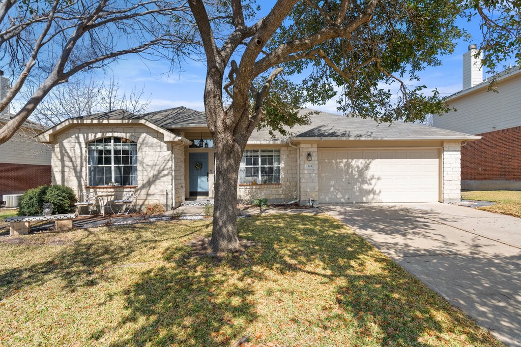 2305 Candle Ridge Trail Georgetown, TX 78626 - Photo 1 of 1 a front view of a house with a garden