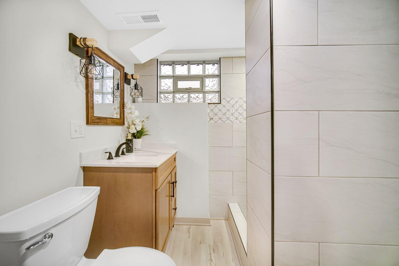 7405 South McCook Avenue Hammond, IN 46323 - Photo 21 of 28 a bathroom with a toilet sink and mirror