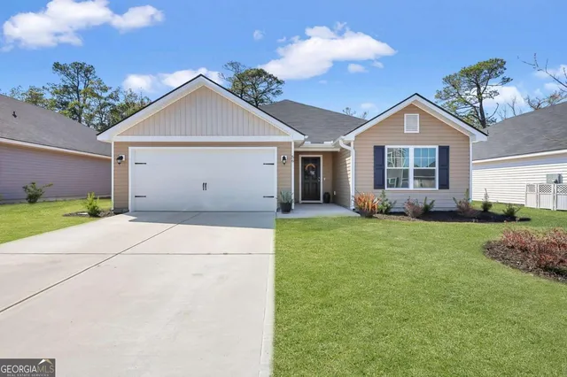 a view of a house with a yard and potted plants