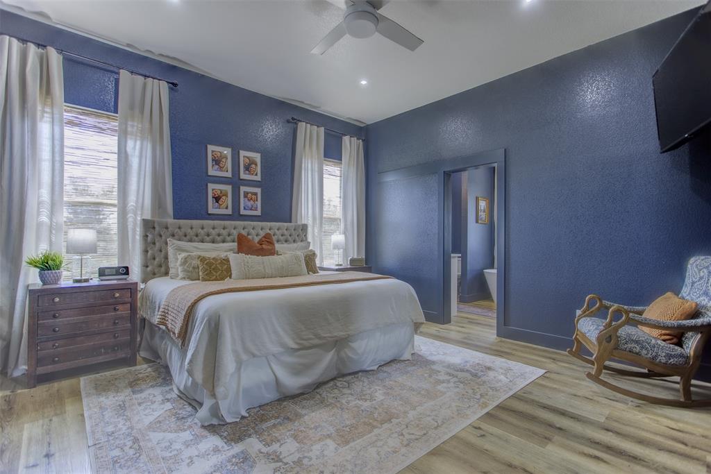 550 Capstone Rdg Road Santo, TX 76472 - Photo 13 of 40 Bedroom featuring a textured wall, wood finished floors, ensuite bath, a ceiling fan, and recessed lighting