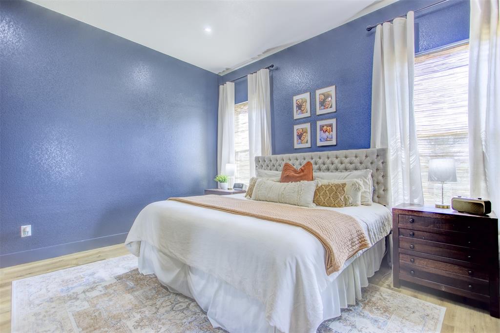 550 Capstone Rdg Road Santo, TX 76472 - Photo 14 of 40 Bedroom featuring a textured wall, wood finished floors, and baseboards