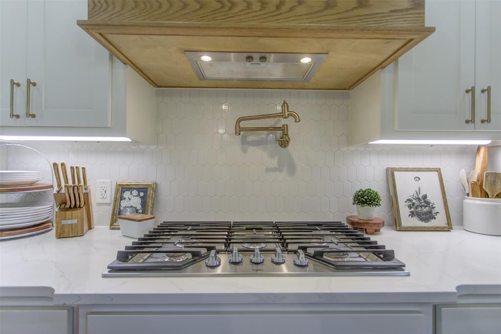 550 Capstone Rdg Road Santo, TX 76472 - Photo 16 of 40 Kitchen view of stainless steel gas stovetop, decorative backsplash, pot filler, and light stone countertops
