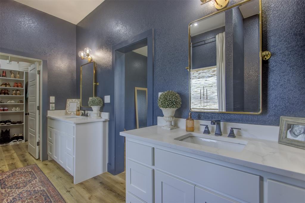 550 Capstone Rdg Road Santo, TX 76472 - Photo 17 of 40 Full bath featuring a textured wall, wood finished floors, and two vanities