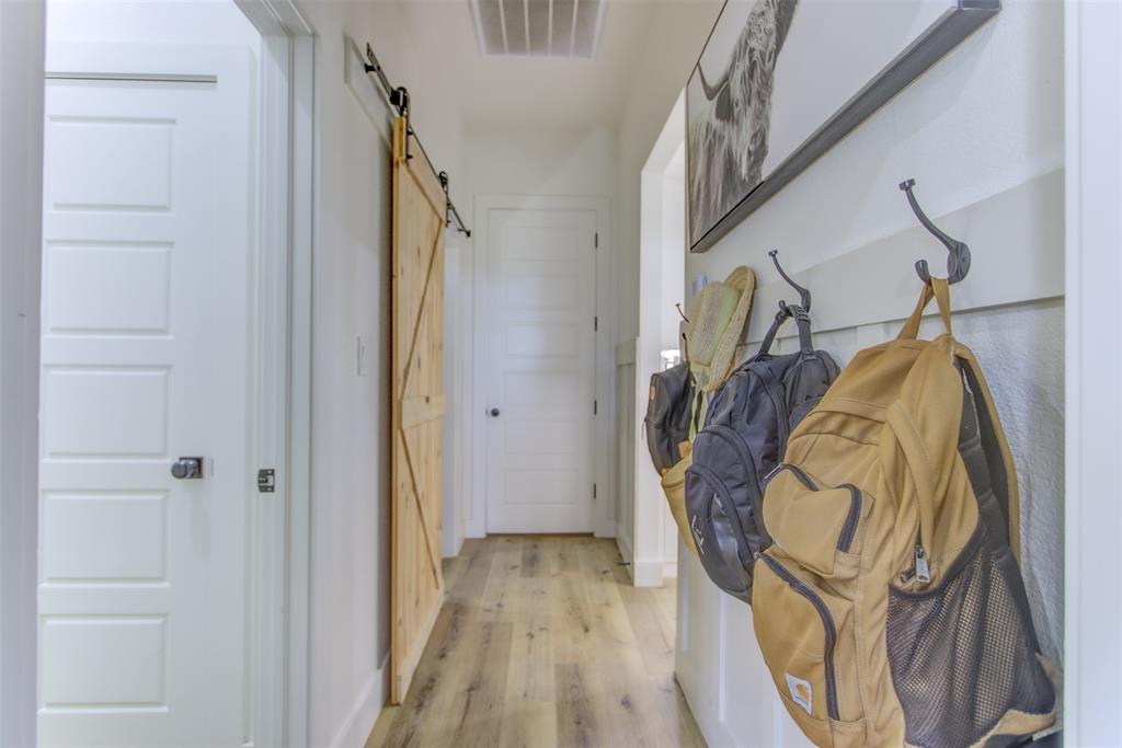 550 Capstone Rdg Road Santo, TX 76472 - Photo 20 of 40 Corridor featuring a barn door and light wood-type flooring