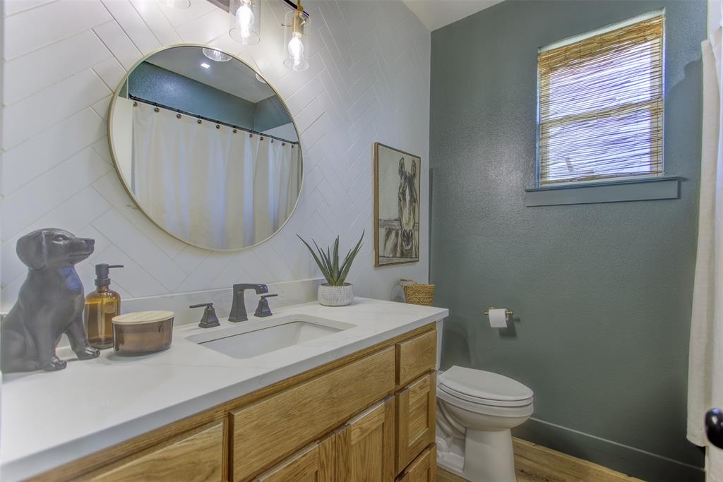 550 Capstone Rdg Road Santo, TX 76472 - Photo 22 of 40 Bathroom featuring vanity, toilet, wood finished floors, baseboards, and a textured wall