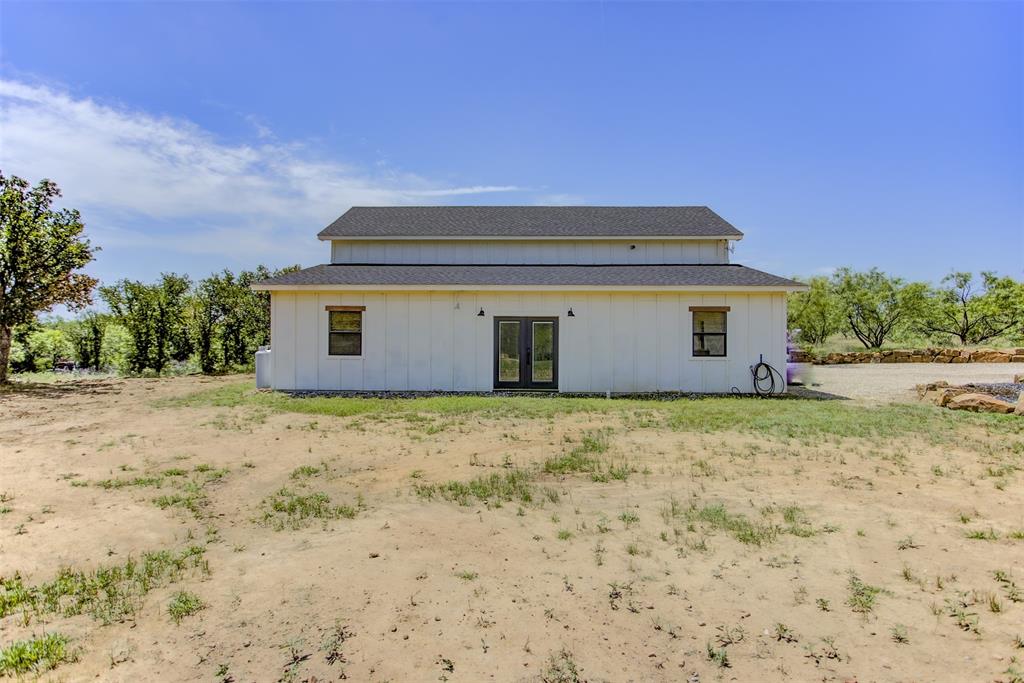 550 Capstone Rdg Road Santo, TX 76472 - Photo 30 of 40 Rear view of apartment featuring french doors, board and batten siding, and a shingled roof